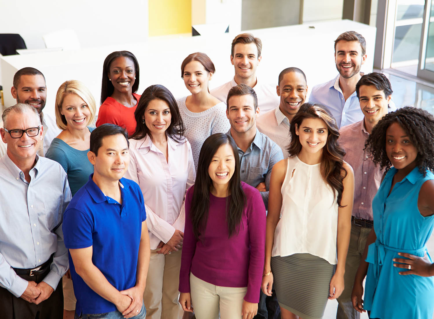 group of diverse individuals smiling at camera