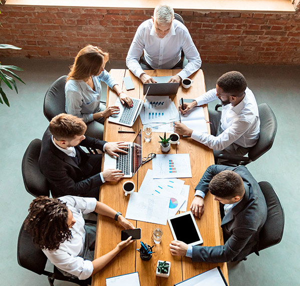 group of employees around a table in meeting