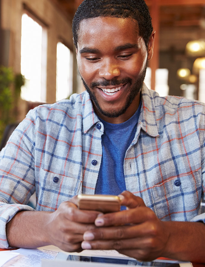 man smiling at his phone