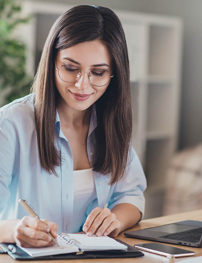 woman writing a note in her planner