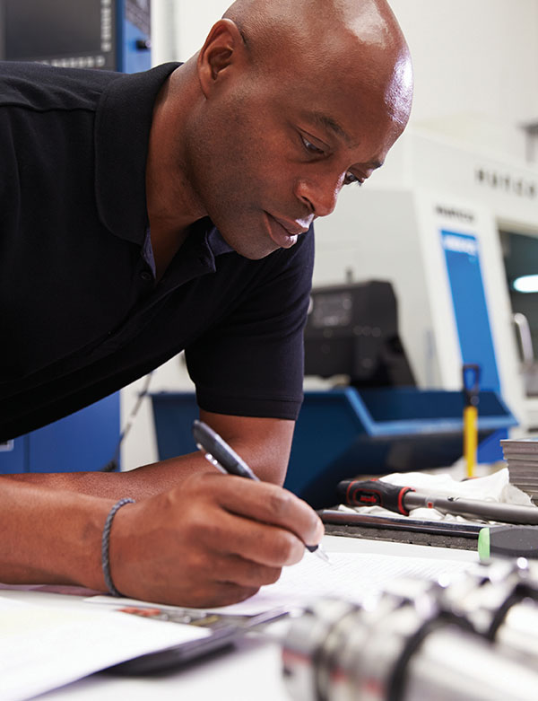 man writing notes on legal pad