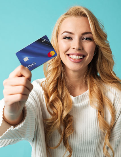 woman smiling holding a credit card