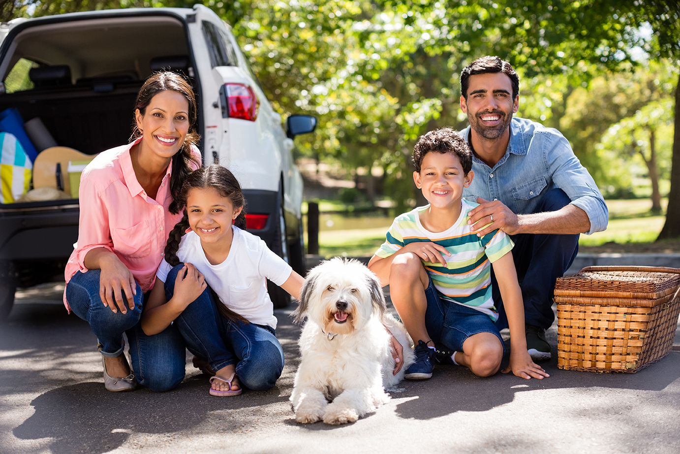 family with dog and picnic basket