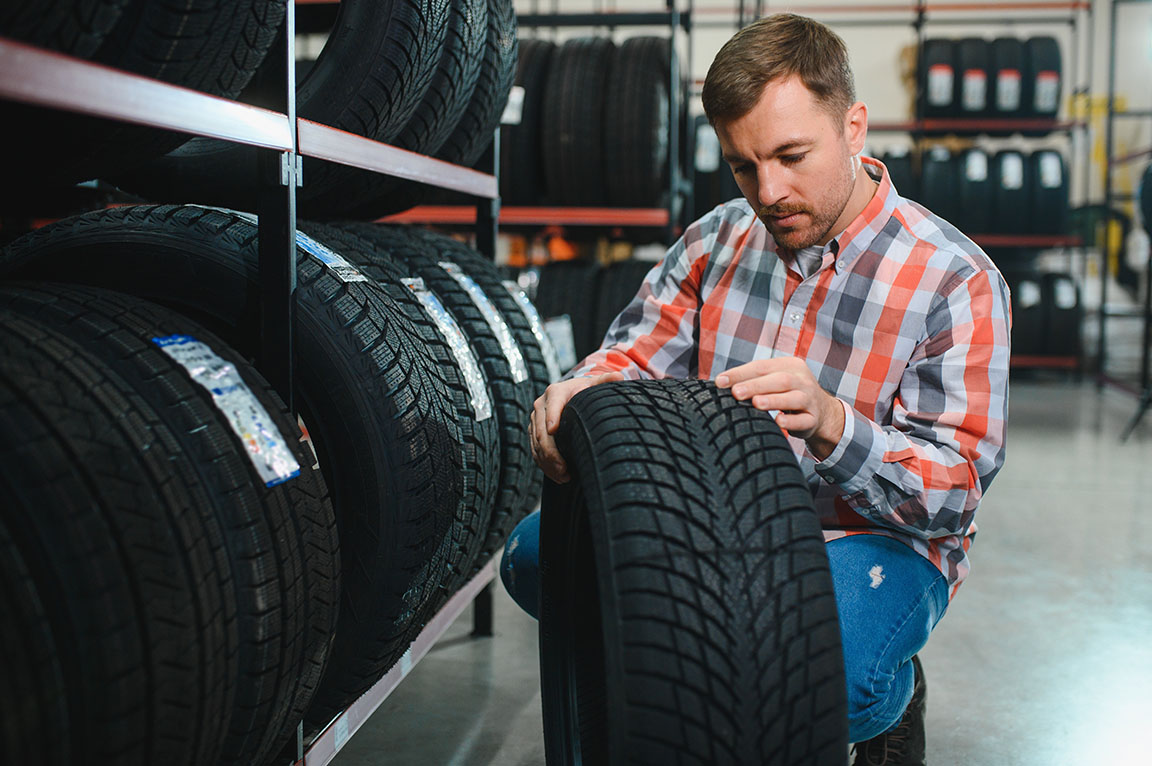  young man buying new tires 